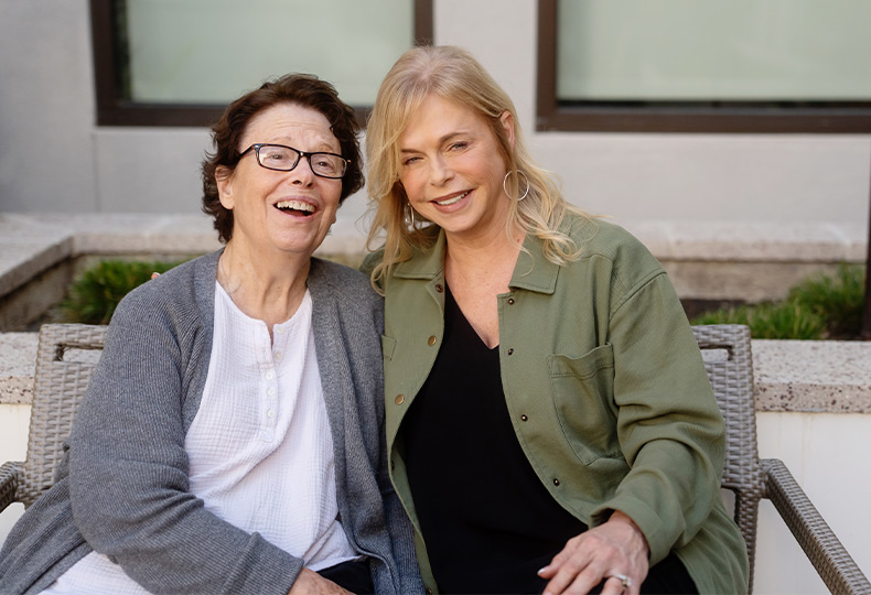 Two people sitting and laighing.