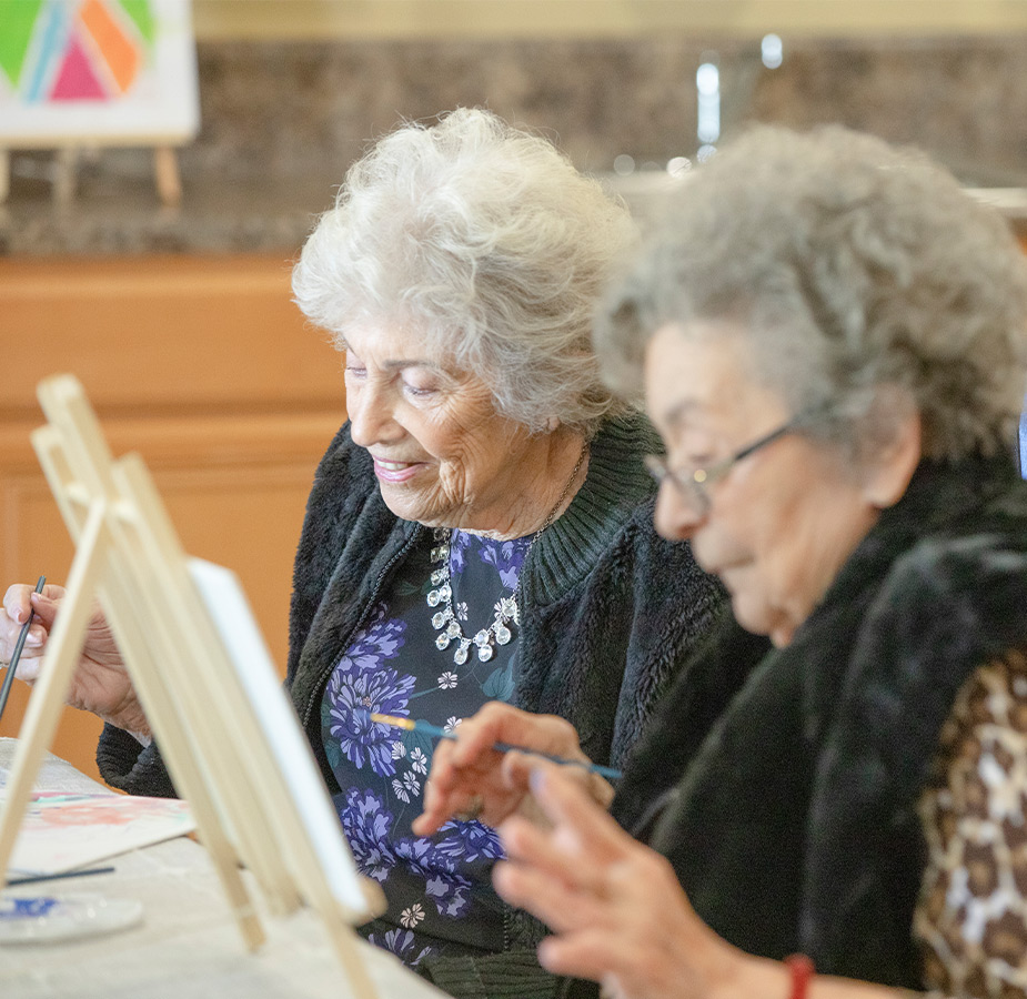 Two people painting.
