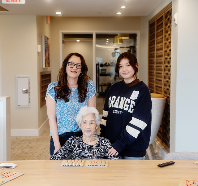 People at a table with a bingo card.
