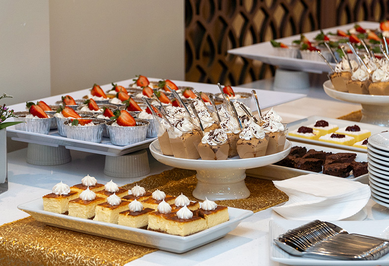 A bunch of bite sized desserts on a table.