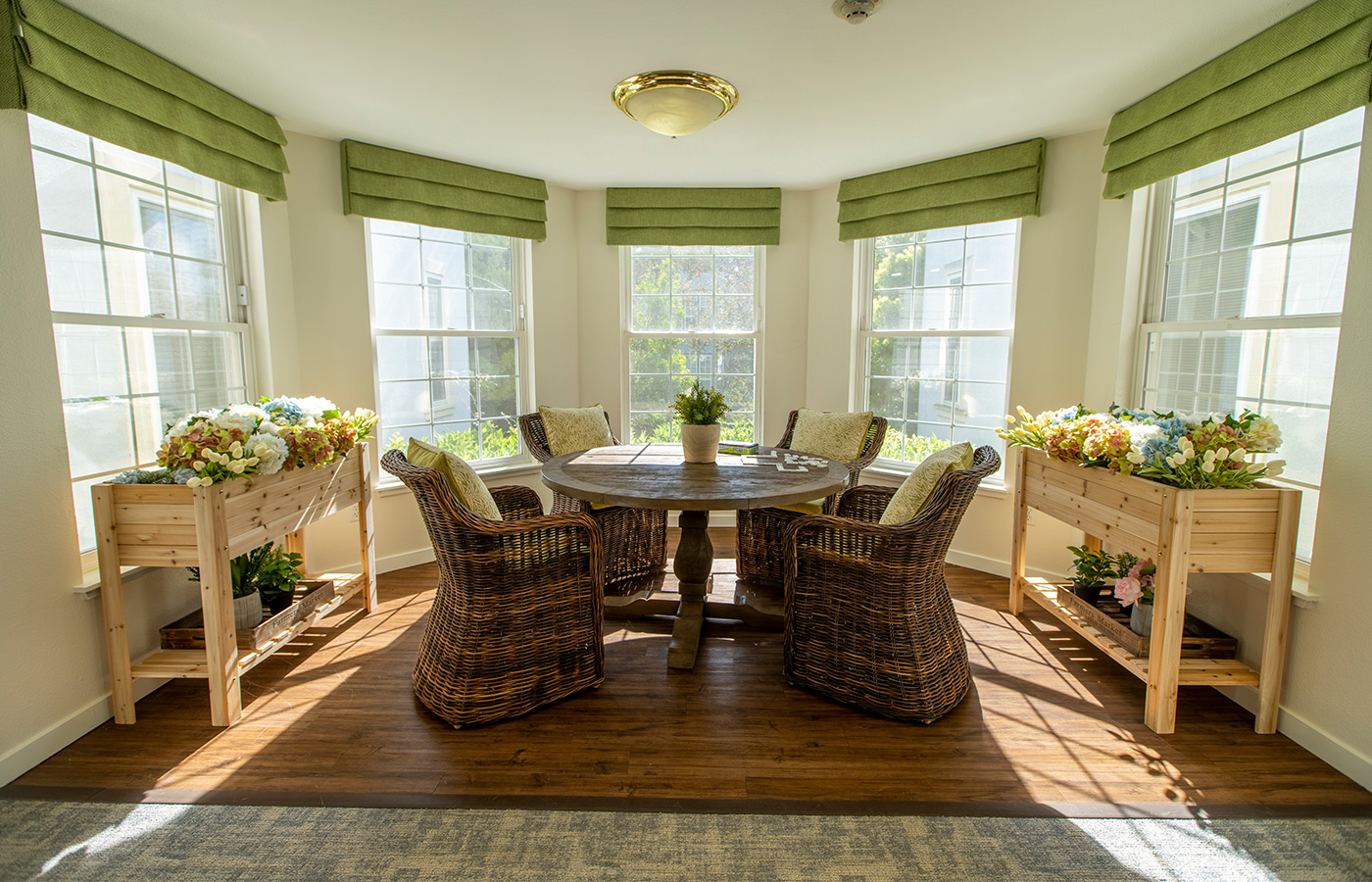 table and chairs in front of bright windows