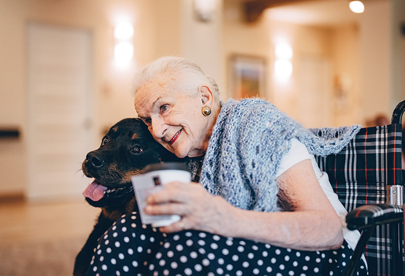 A resident hugging a dog.