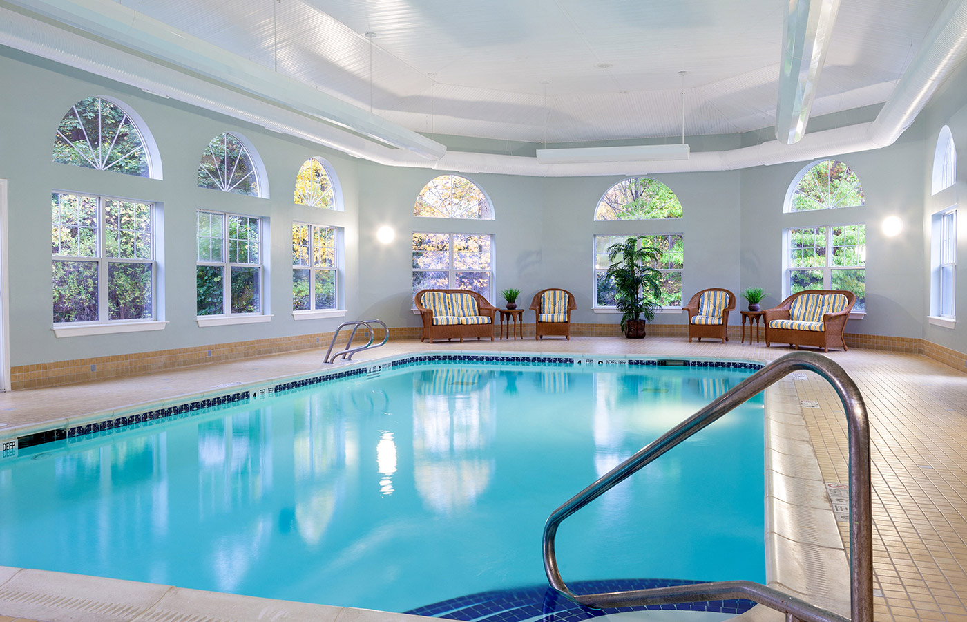 Indoor pool with seating area.