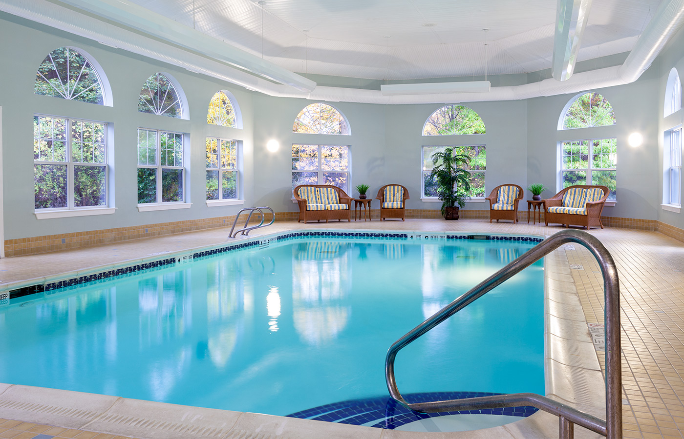 Indoor pool with seating area.