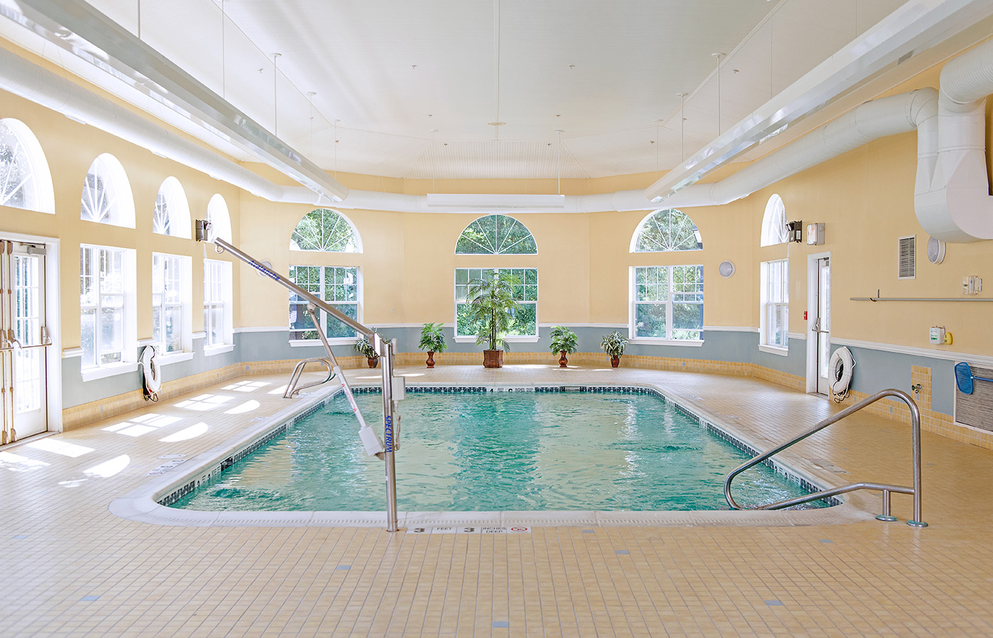 Indoor pool with seating area.