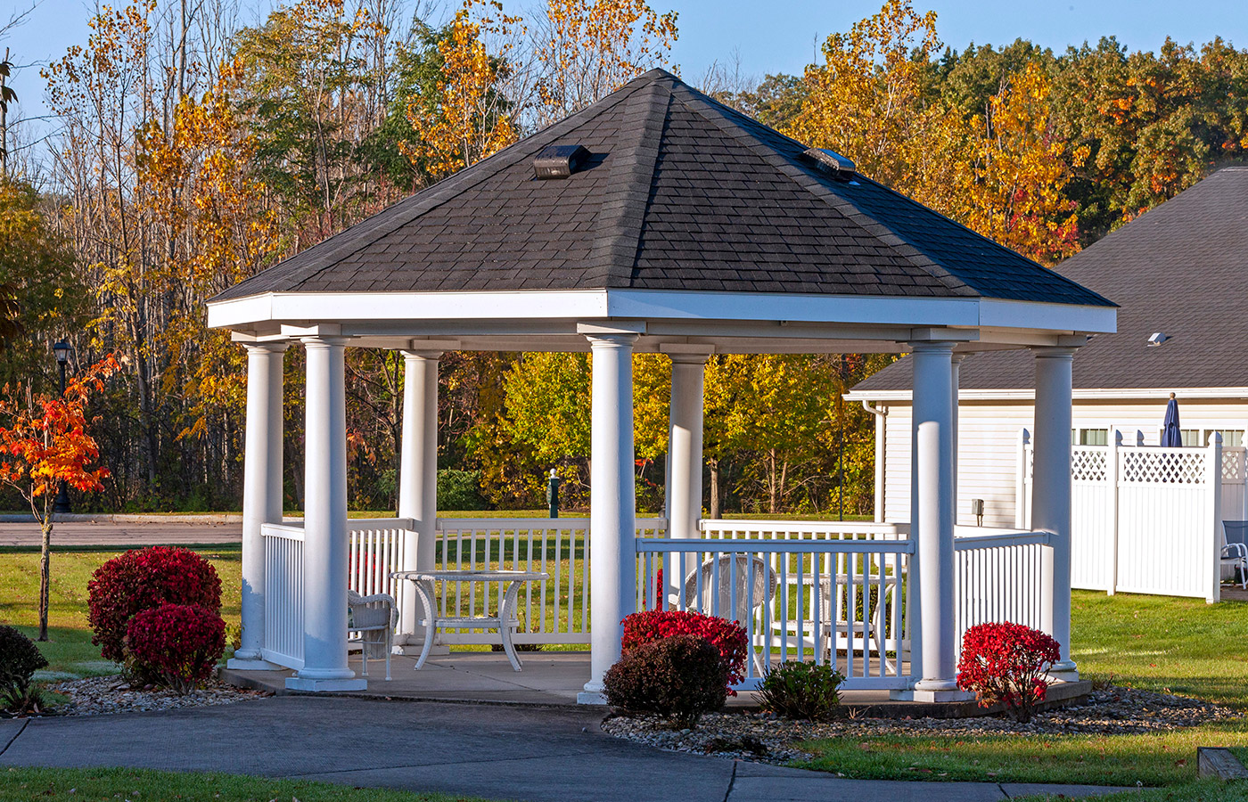 Gazebo surrounded by bushes.