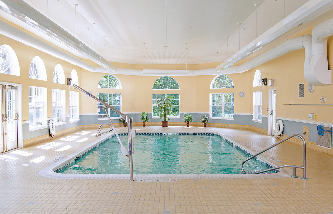 Indoor pool with seating area.