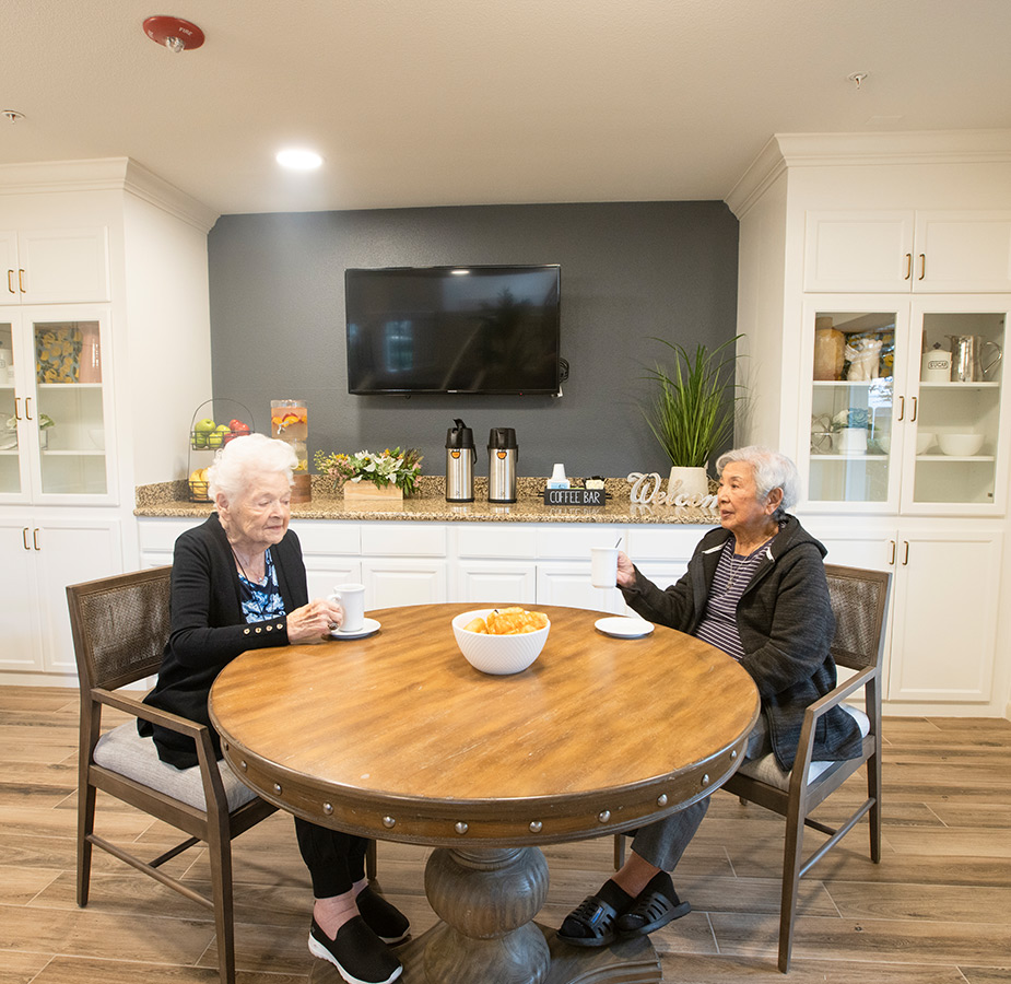 Two residents enjoy a cup of coffee.
