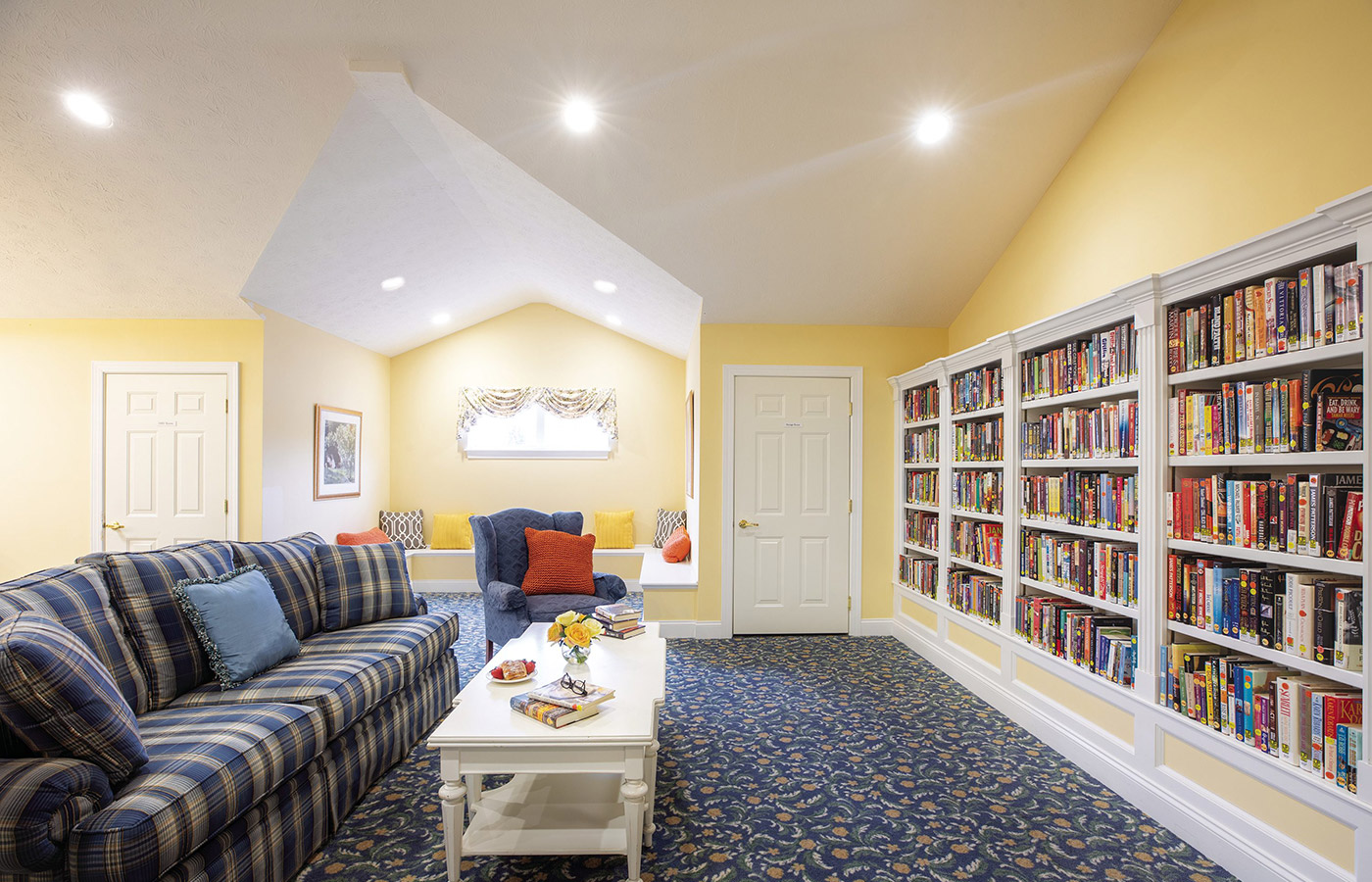 large sofa facing long book shelf within library