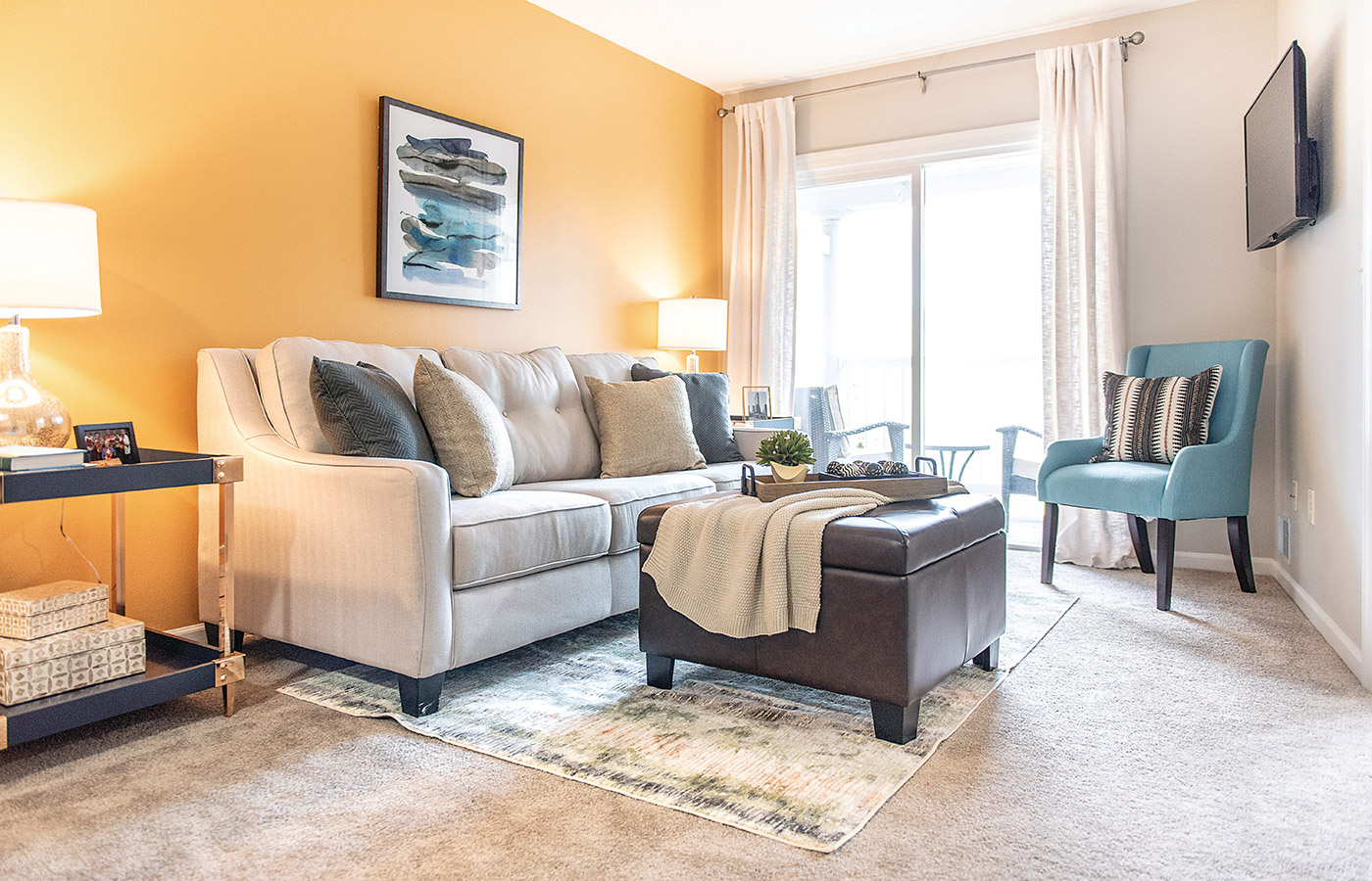 Furnished living room space with sofa, table, and seating area.