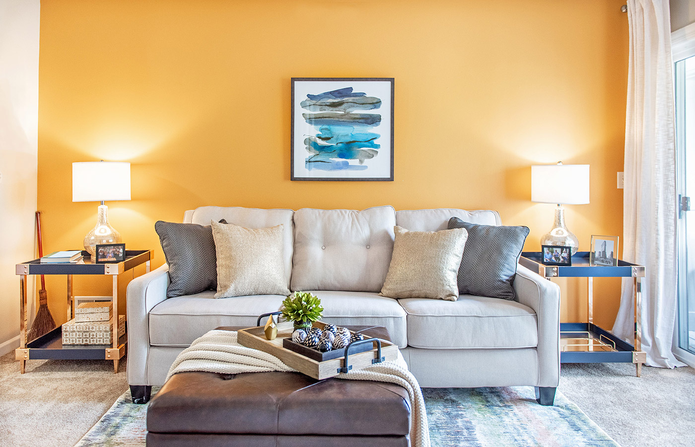 Furnished living room space with sofa, table, and seating area.