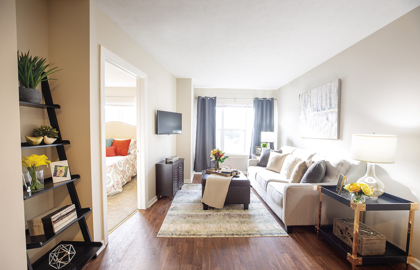 Furnished living room space with sofa, table, and seating area.