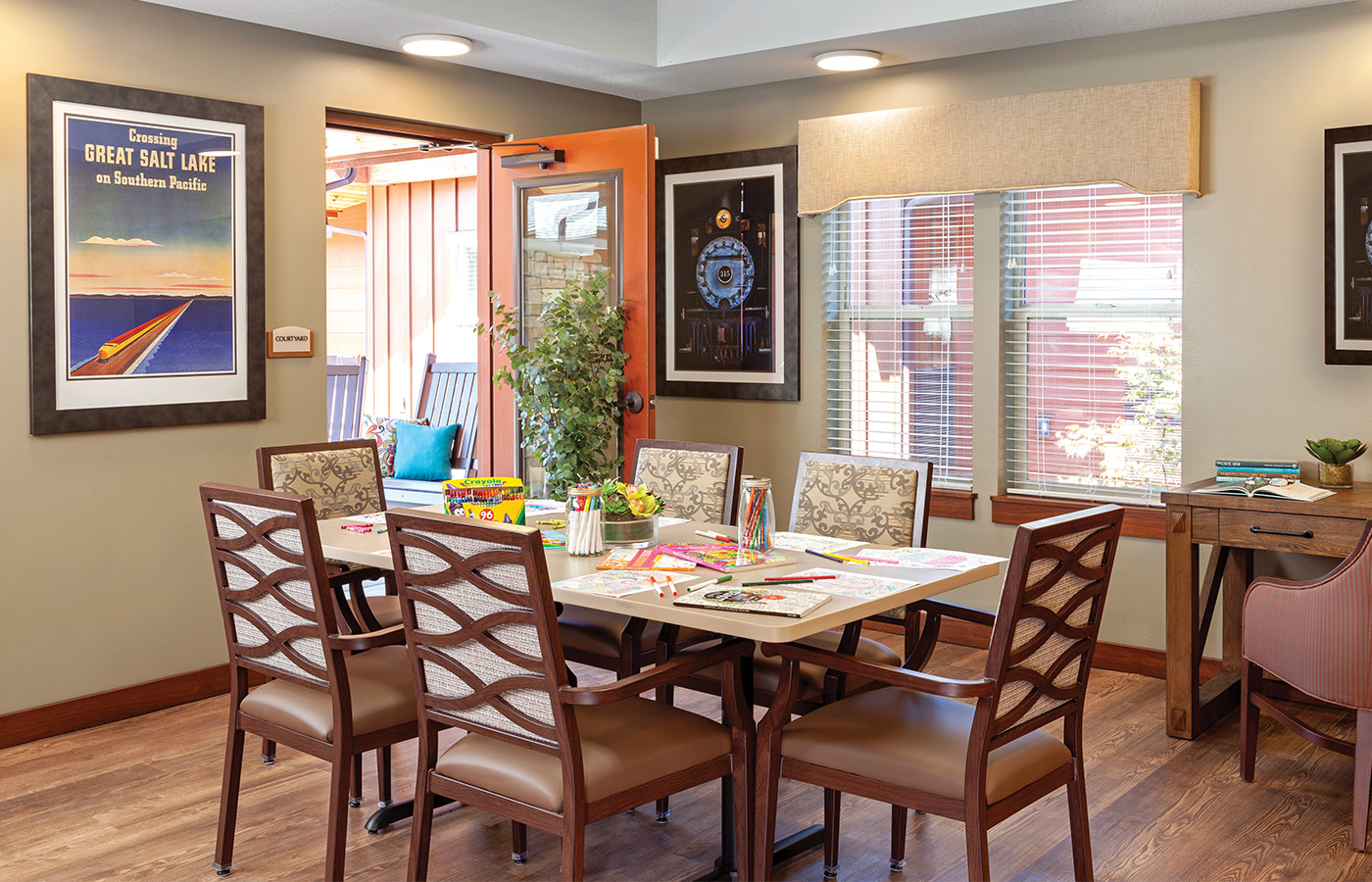 Set dining room table with art on walls.