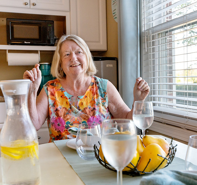 A person at their dining table with water.