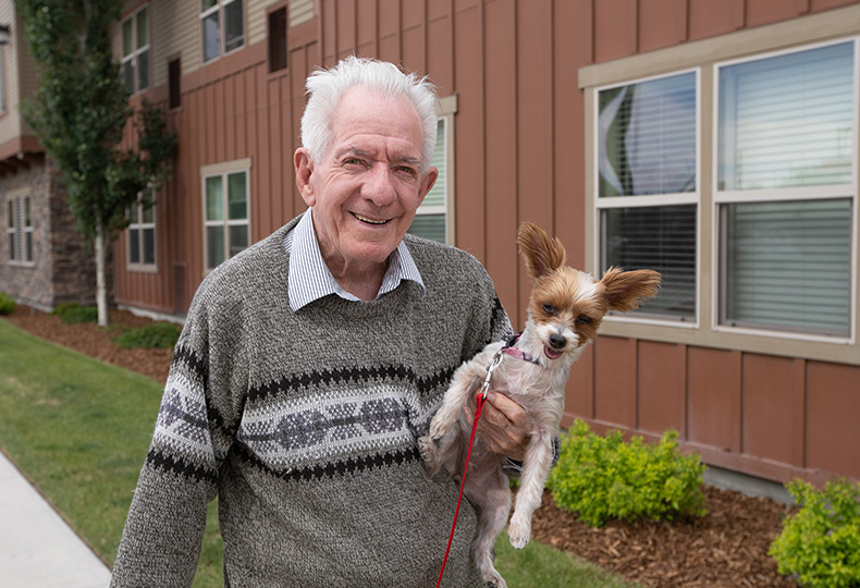 A resident holds his chihuahua dog.