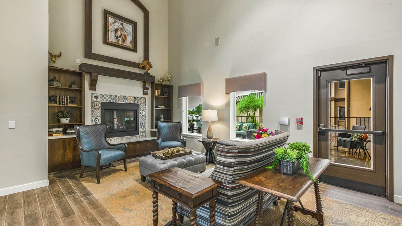 A seating area in front of a fireplace at The Watermark at Continental Ranch.