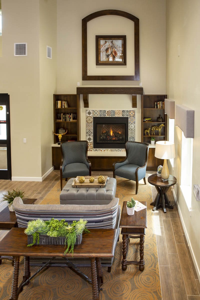A seating area in front of a fireplace at The Watermark at Continental Ranch.