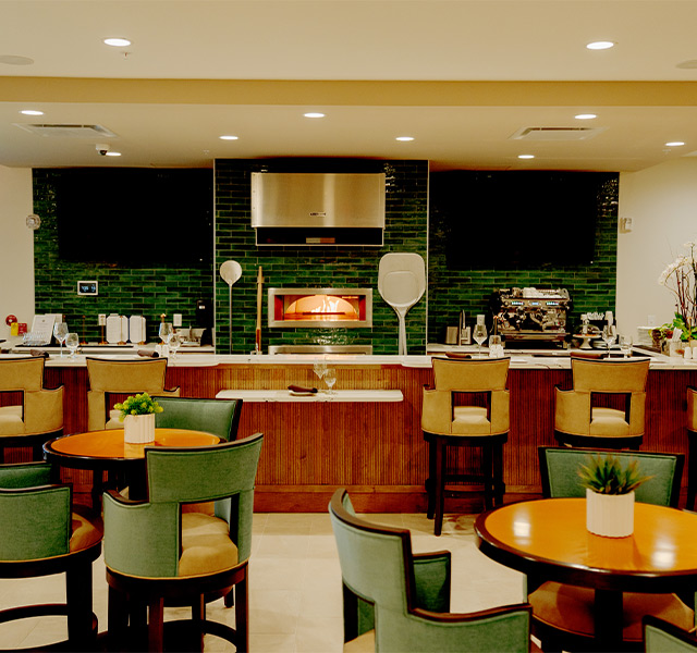 A restaurant with a fire pizza oven.