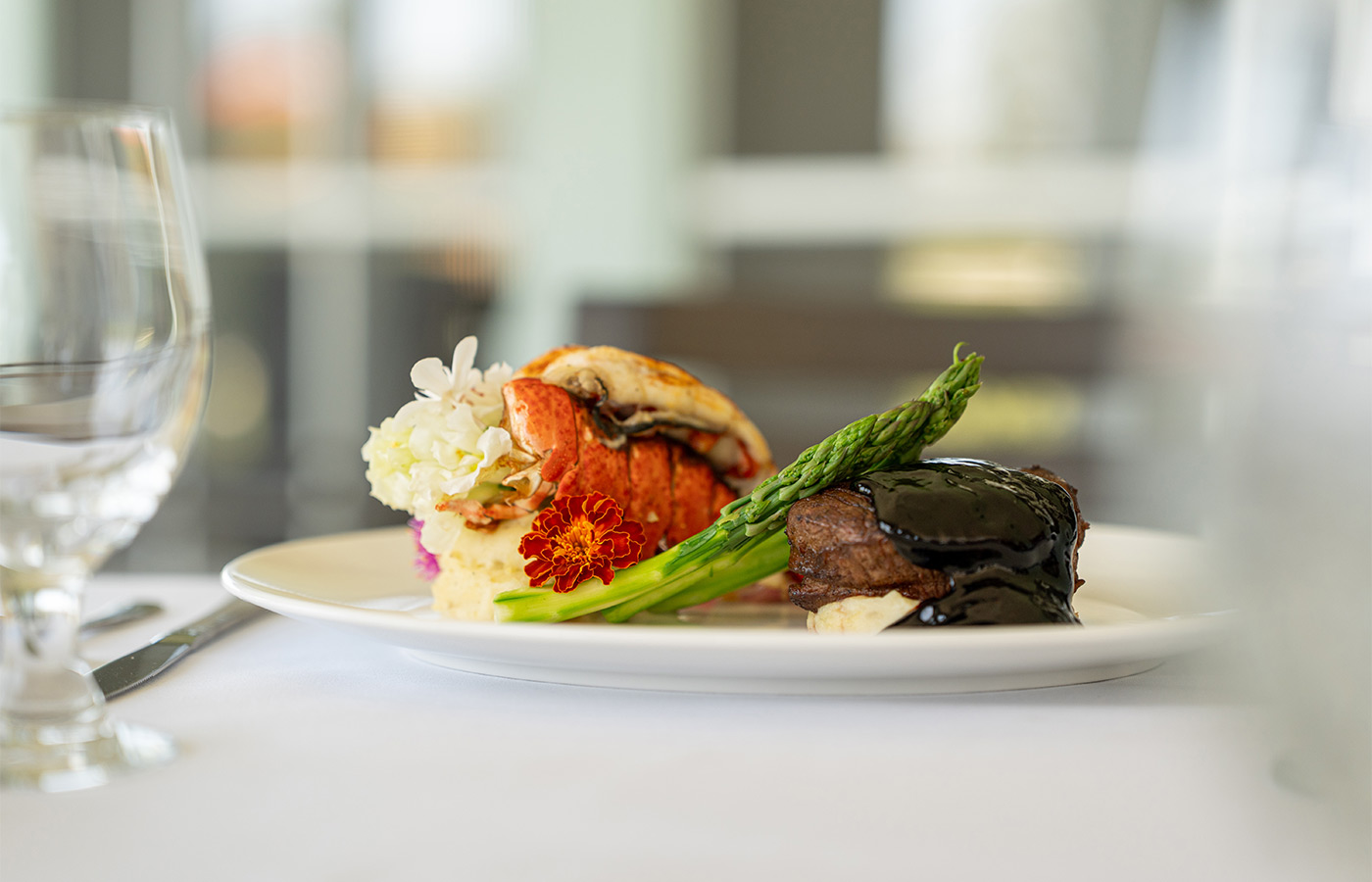 Steak and lobster on a plate.