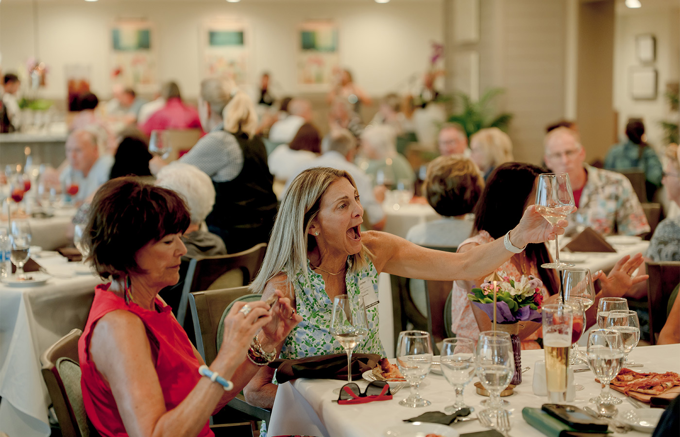 People toasting with drinks.