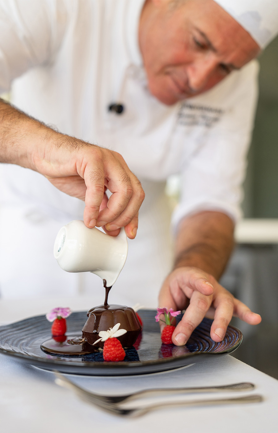 A chef making a dessert.