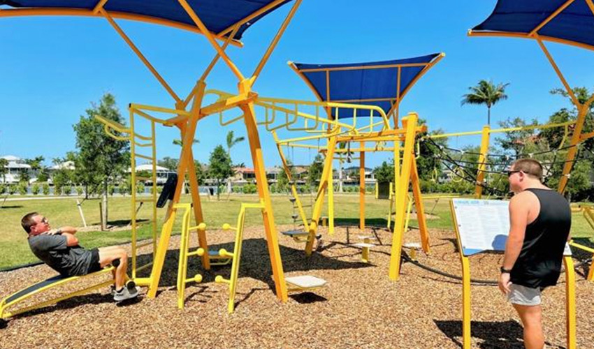 Two people at outdoor gym.