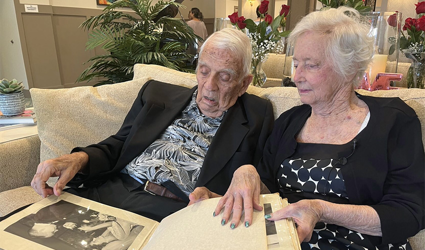 A couple is looking at an old photo album.