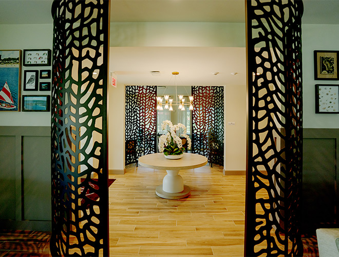 A lounge with a table and floral piece.