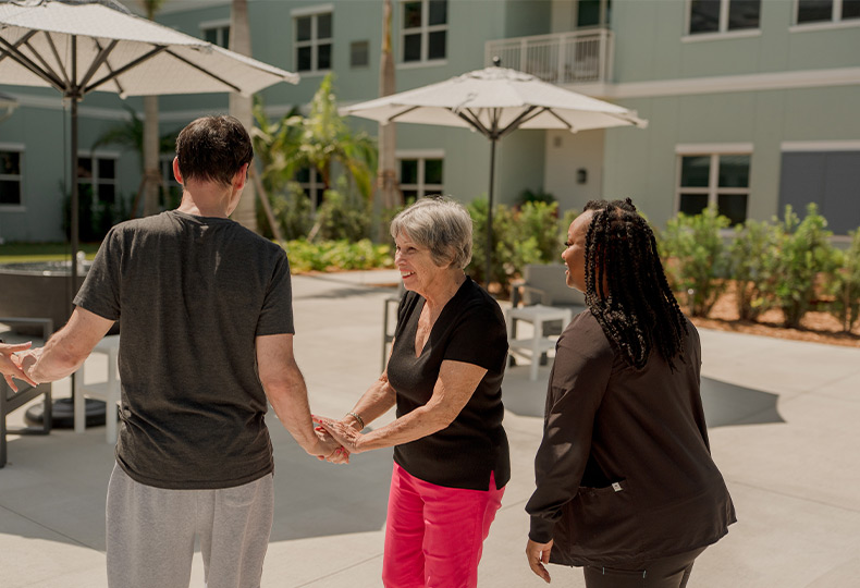 People outside shaking hands.