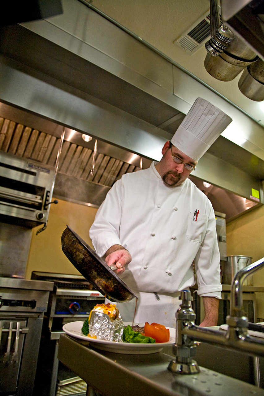 Chef prepares meal.