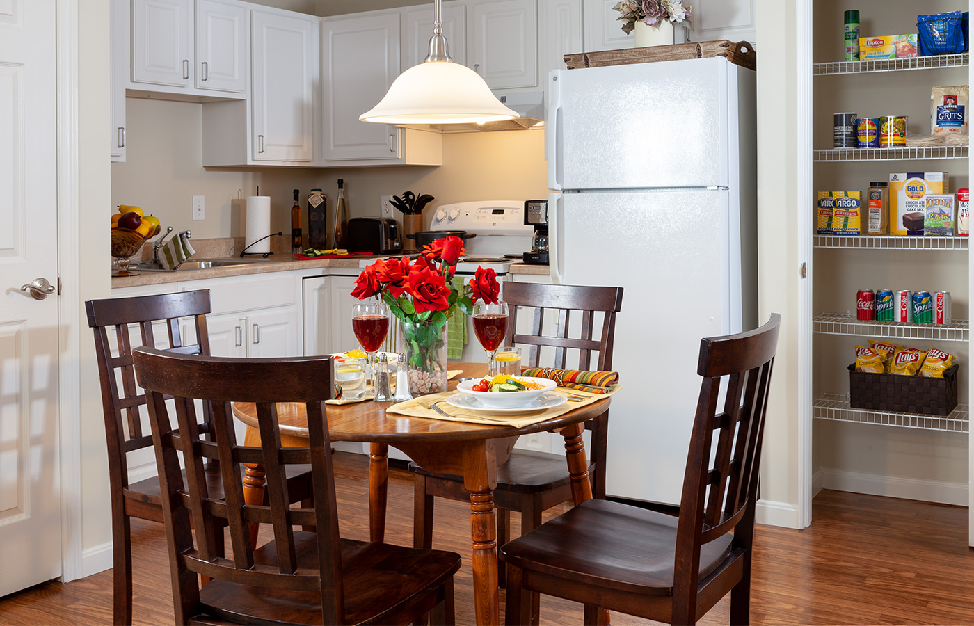 Dining table with chairs and flowers in apartment.