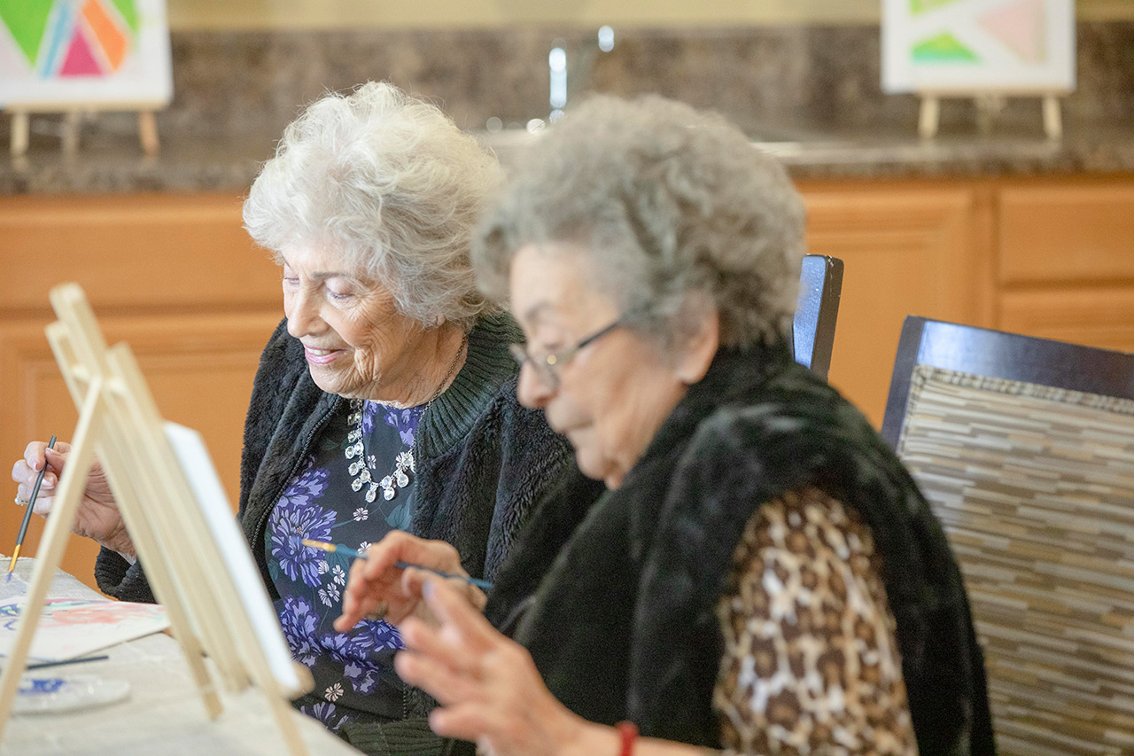 Residents are painting in an art class.