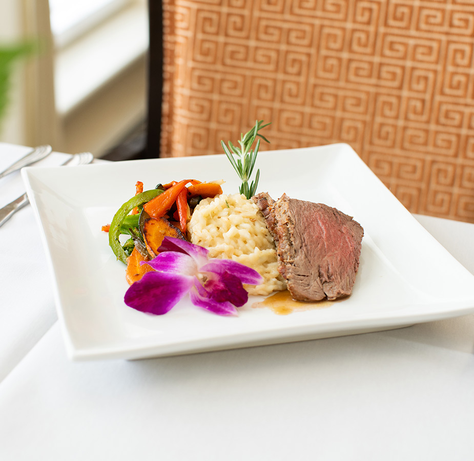 A plate with steak and vegetables on it.