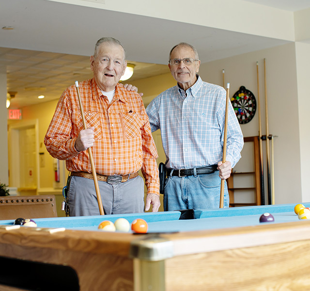 Two friends playing pool.