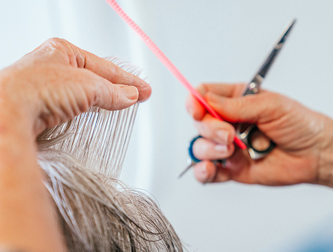 A resident is getting their hair done at the salon.
