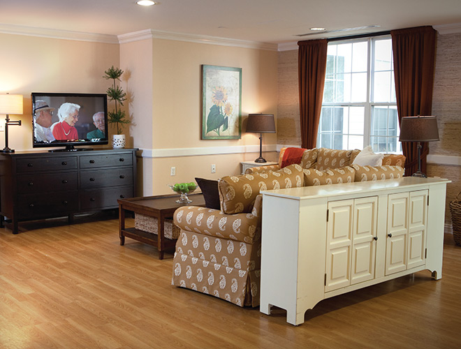 Furnished living room space with sofa, table, and seating area.