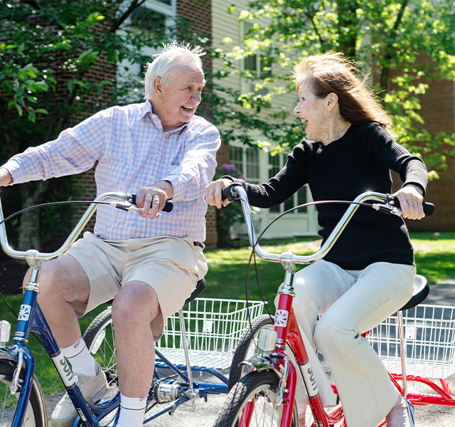 Two people riding bikes.