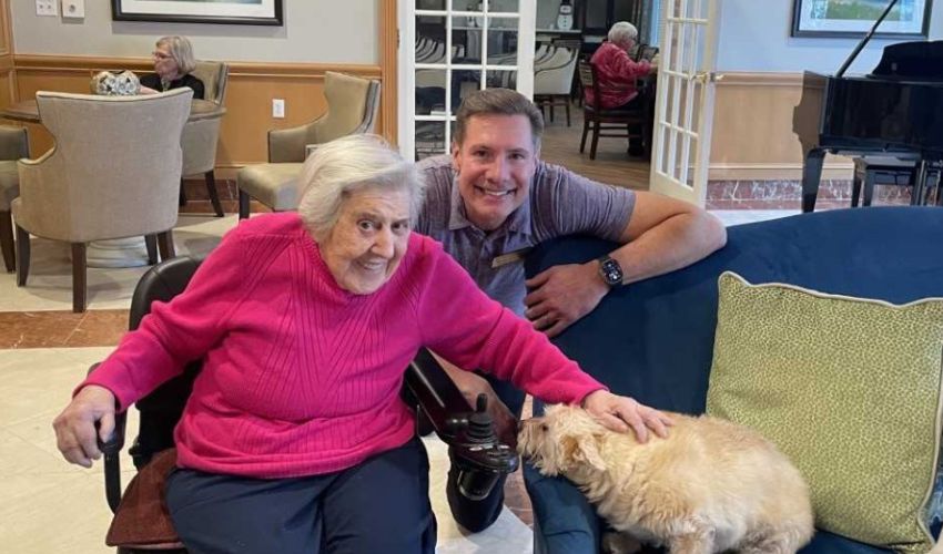 Two people petting a dog.