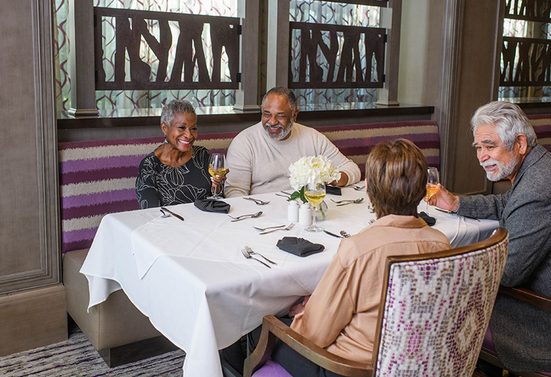 Two couples having dinner.