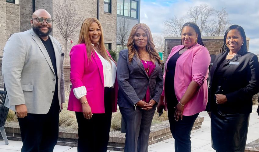 A group of people standing outside.