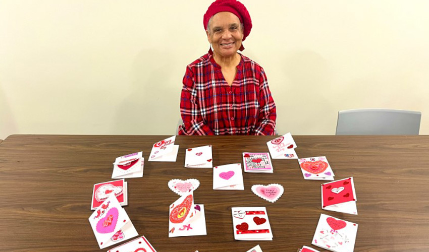 A person with a table full of handmade cards.