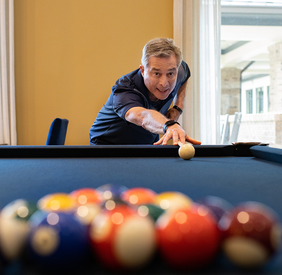A resident playing pool.