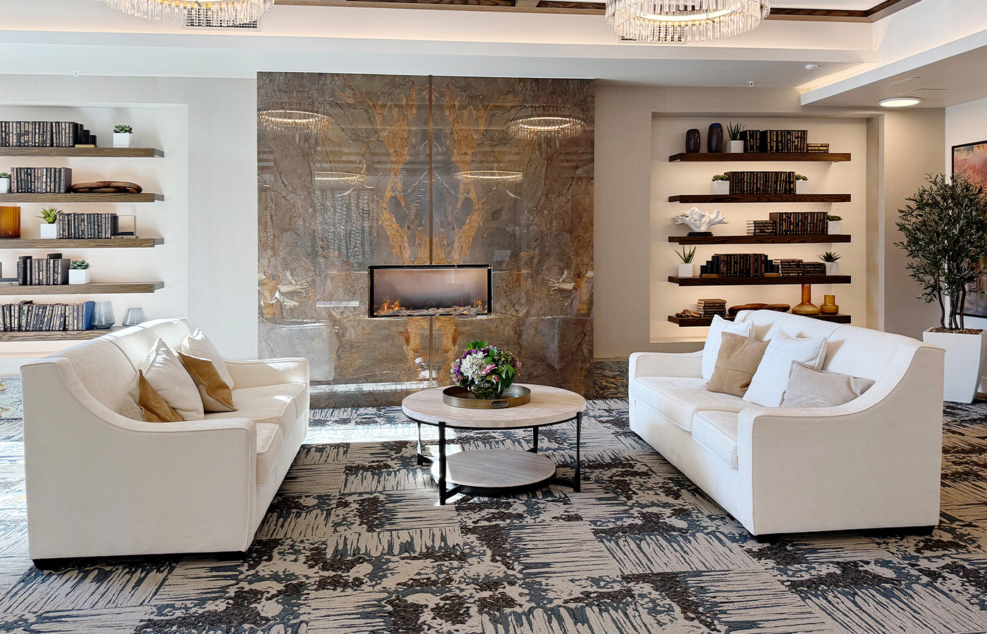 A living room with couches and a fireplace.