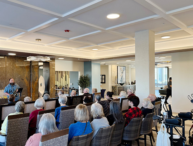 A group of people watching a musician perform.