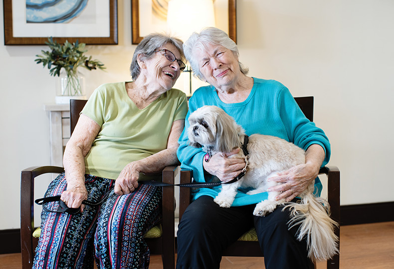 Two people with their pet dog.