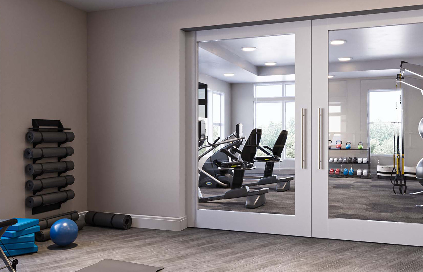 A fitness center with two rooms and exercise equipment.