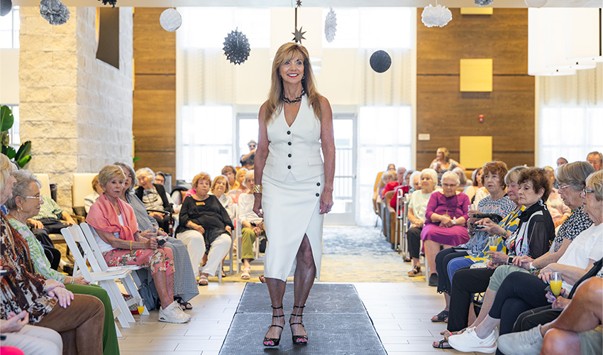 A person walking the catwalk at a fashion show.