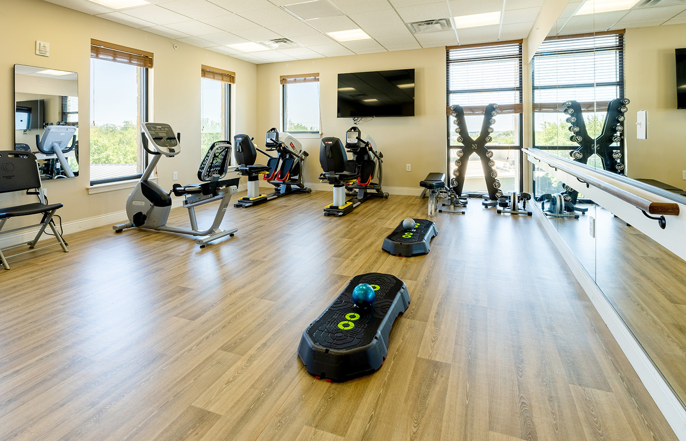 A fitness room with exercise equipment.