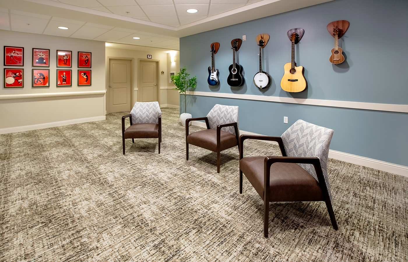 A music area with chairs and guitars on the wall.