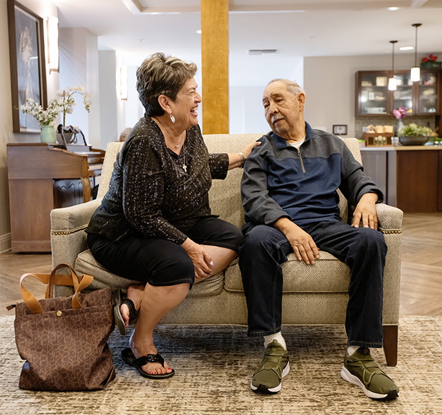 A resident and his wife on the couch.